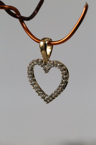 Heart-shaped pendant in 14 carat gold, with diamonds. Stamped 585. Very 
exclusive.