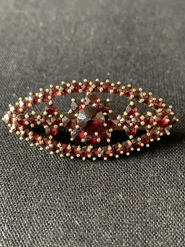 Silver brooch from HGR with garnets.
Length: 3.6 cm