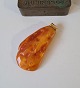 Large polished amber lump with the eyelet in 14 kt gold 27.6 grams.