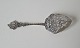 Serving spade in silver richly decorated with flowers and ship