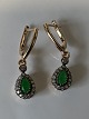 Earrings in 14 carat gold with beautiful green emeralds and white stones.