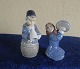Royal Copenhagen Denmark, pair of figurines Nos 3677 Girl with pot lid and No 
3689, Boy with horn