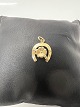 14 karat guld. Hestesko med en Firkløver. Charms / Vedhæng.Højde 1,8 cm.
