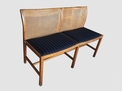Bench with fabric seats
Søren Horn
Mahogany. Plaited back. Seat in black fabric. 
Length: 110 cm, Height: 78 cm.
From the 1960s. 
Ditte & Adrian Heath
